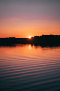 Scenic view of lake against romantic sky at sunset