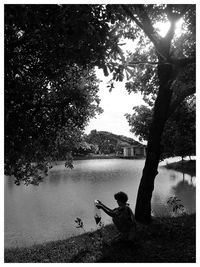 Rear view of man looking at lake