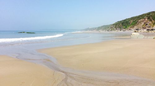 Scenic view of beach against clear sky