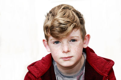 Close-up portrait of boy against white background