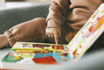 Close-up of baby hand on table