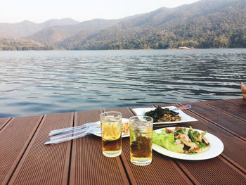 High angle view of beer on table by lake