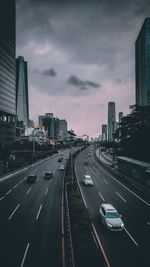 Vehicles on road at sunset