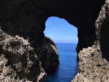 Scenic view of sea seen through cave