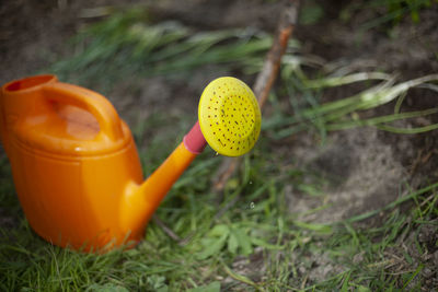 Watering can for watering garden. orange watering can with yellow shower. 