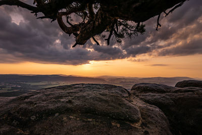 Scenic view of rock formation against sky during sunset