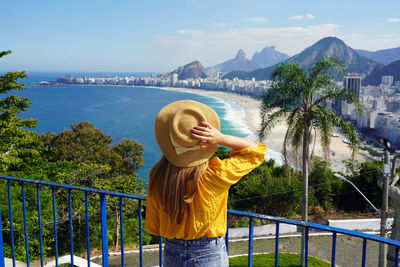 Traveler girl enjoying view of copacabana beach in rio de janeiro, brazil.