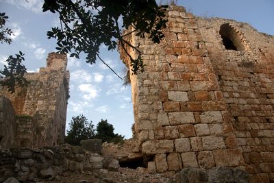 Low angle view of old ruin building against sky