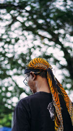 Portrait of a woman against blurred trees