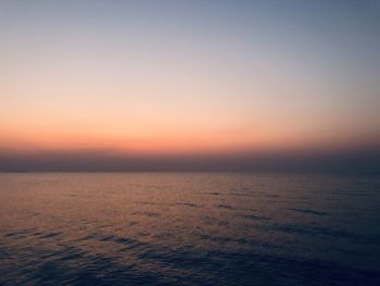 Scenic view of sea against clear sky at sunset