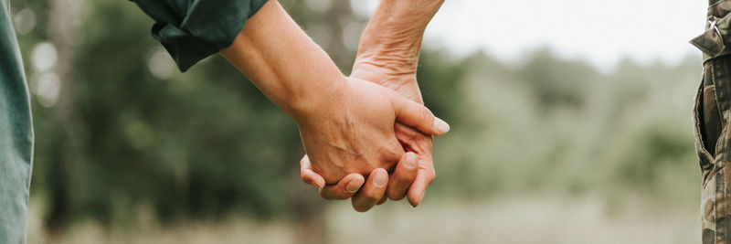 Happy senior couple holding hands. hands of man and woman hold each other. romance and love