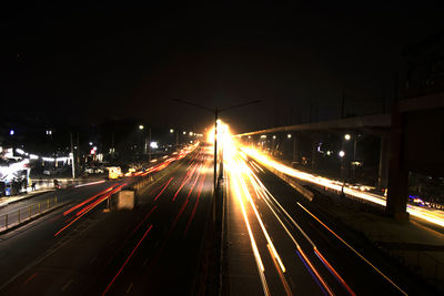 High angle view of light trails on highway at night