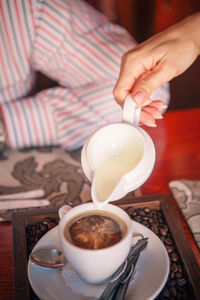 Midsection of coffee cup on table