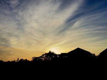 Silhouette trees against sky during sunset