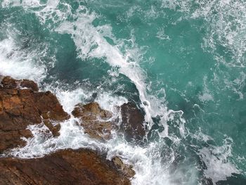 Waves splashing on rocks at shore