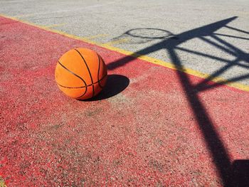 Ball on basketball court during sunny day