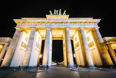 Low angle view of illuminated building at night