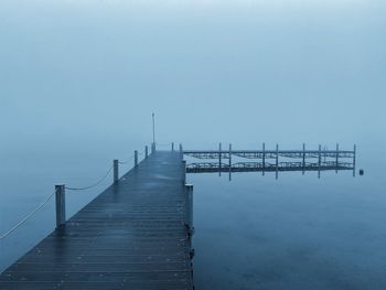 Pier over sea against clear sky