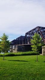 Arch bridge over water against sky