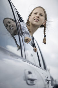 Girl looking through car window