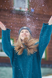 Portrait of a smiling young woman in snow