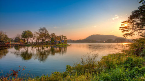 Scenic view of lake against sky during sunrise