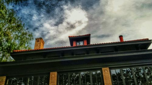 Low angle view of building against cloudy sky