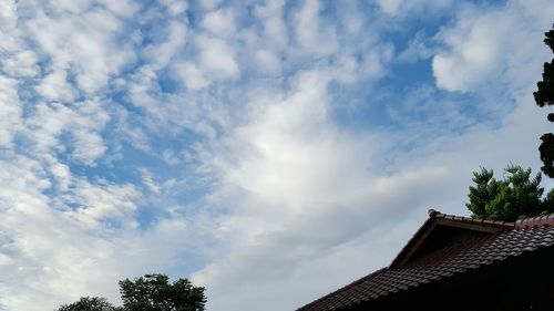 Low angle view of building against cloudy sky