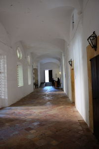 Rear view of man walking in corridor