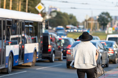 Rear view of woman walking on street in city