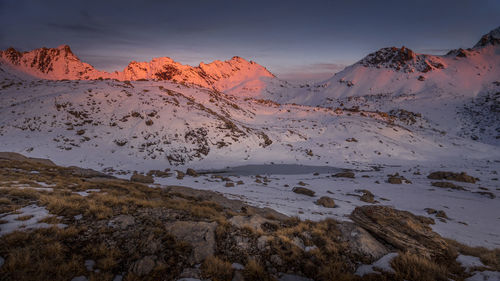 Scenic view of snowcapped mountains against sky during sunset