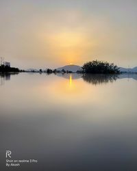 Scenic view of lake against sky during sunset