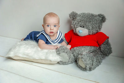 Portrait of cute baby girl lying on bed at home