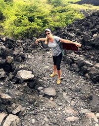 High angle view of female hiker standing on mountain