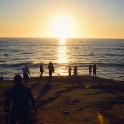 People on beach at sunset