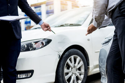 Low section of people standing on car