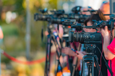 Group of cameras at an outdoor press conference