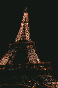 Low angle view of illuminated tower against sky at night