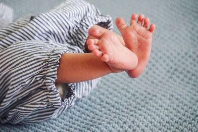 Low section of baby boy on bed