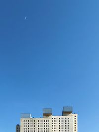 Low angle view of buildings against clear blue sky