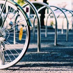 Cropped image of bicycle parked at bicycle rack