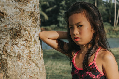 Portrait of a girl with tree trunk