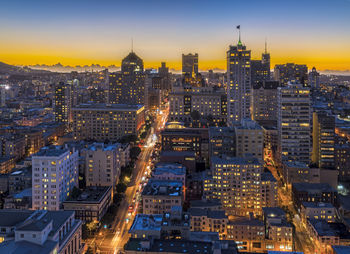 High angle view of city lit up at night