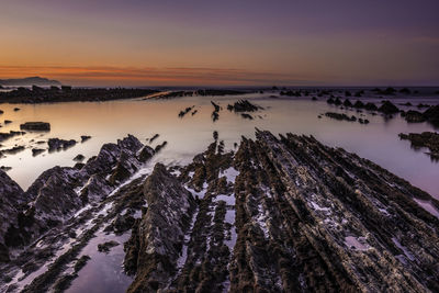 Panoramic view of rocks against sky during sunset