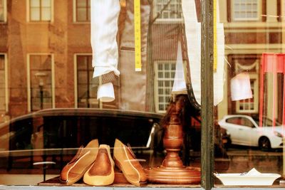 Reflection of people on glass window in building