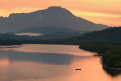 Scenic view of silhouette mountains against sky during sunset