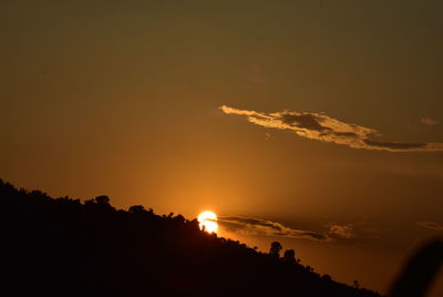 Silhouette trees against sky during sunset