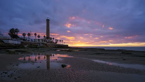 Scenic view of beach against sky during sunset