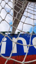 Close-up of rope tied to metal fence