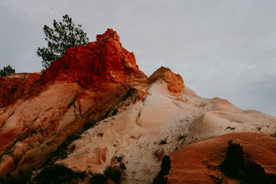 Low angle view of rocky mountains against sky